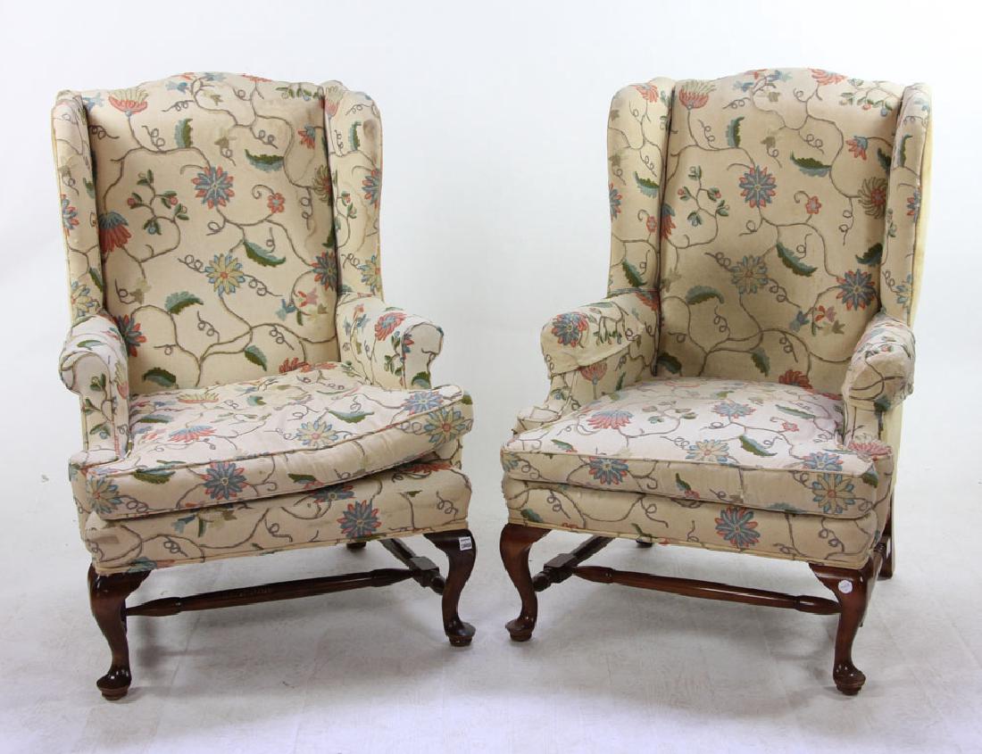 Pr. Queen Anne Style Crewel Work Wingback Armchairs: Pair of Queen Anne-style wingback armchairs, 20th century, with crewel work upholstery in floral motif, on cabriole legs terminating in pad feet, 44" h x 32" w x 29" d.