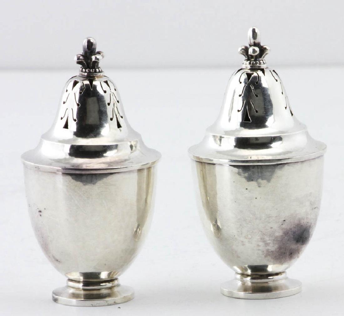 Pair of Georg Jensen Sterling Salts/Peppers: Pair of Georg Jensen sterling silver salts/peppers No. 658, designed by Johan Rohde, 3"h. Approximately 2.9 troy oz TW. Provenance: Private collection Chicago, Illinois.