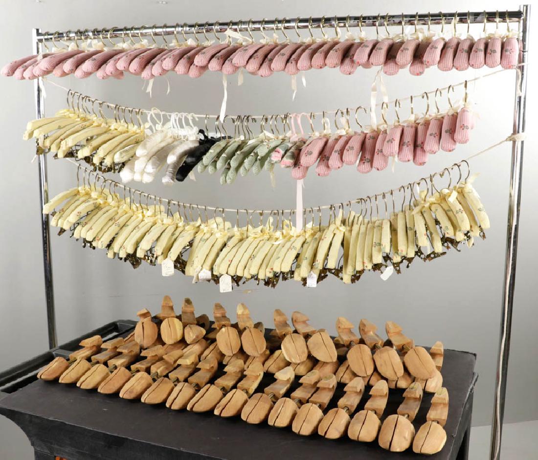 Large Lot of Coat Hangers and Shoe Stays: Large lot of fabric-covered coat hangers and wooden shoe stays.