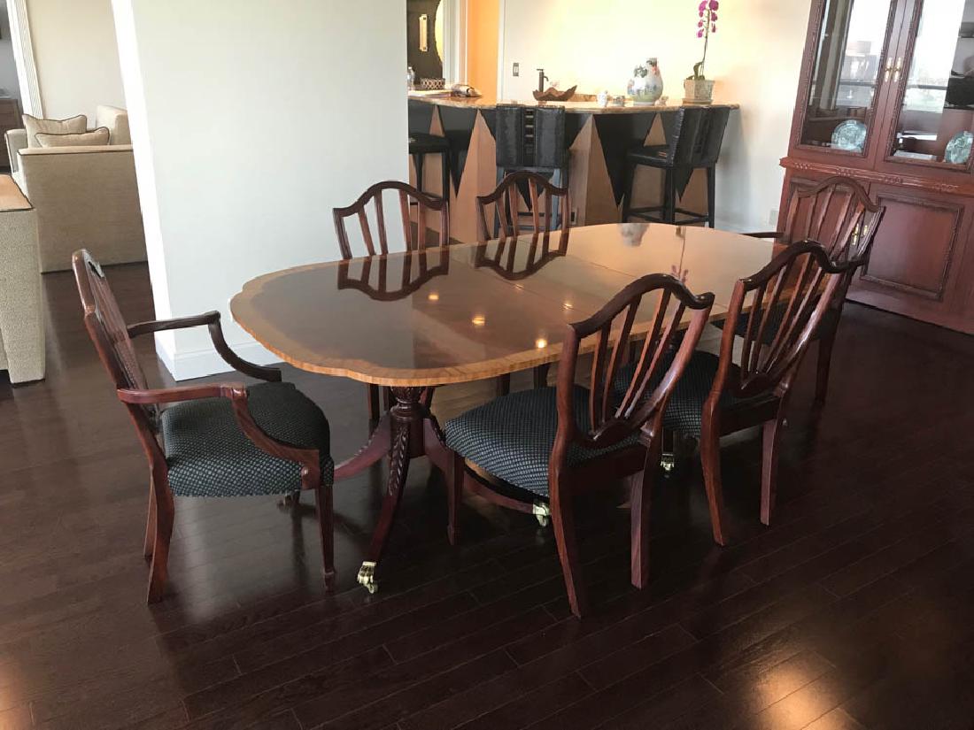 Hepplewhite Style Mahogany Dining Table: Custom Hepplewhite-style mahogany dining table with banded inlay, labeled 'Baker Historic Charleston Collection', 29" H x 71" L x 46" W, with three (3) leaves, 16" x 36", and table pads. Good conditio