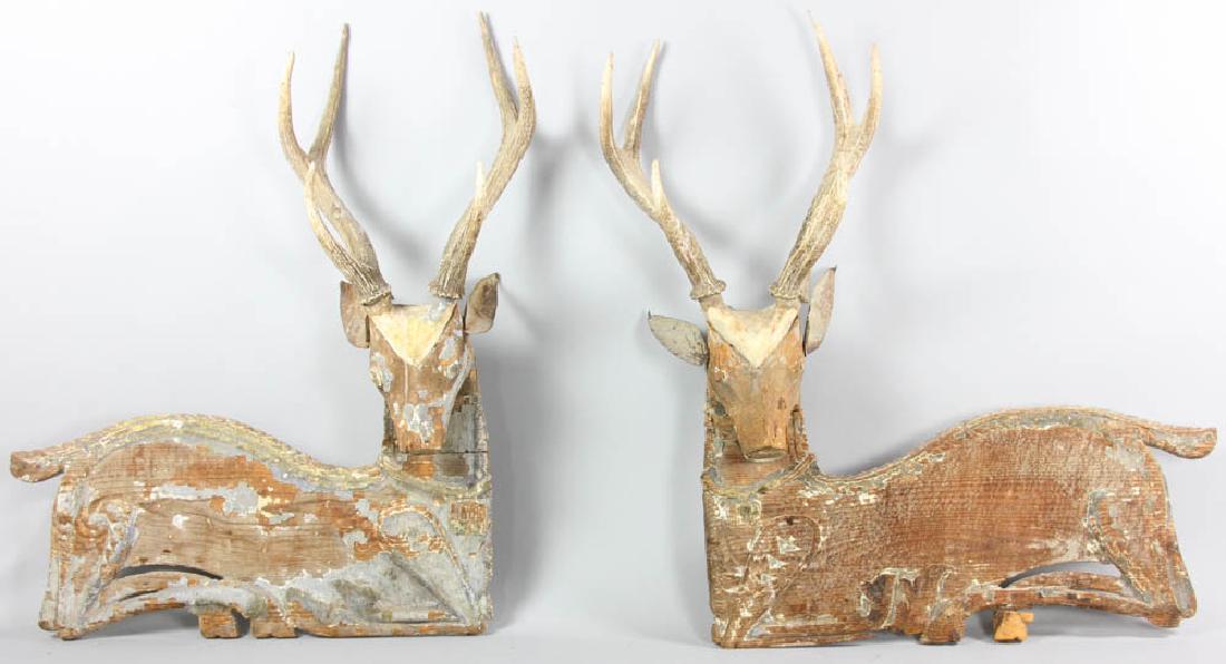 Pair of Indonesian Carved Deer with Antlers: Pair of carved deer, wood and antler, flat panel bodies, Bali, Indonesia, 24 1/2" W x 33" H.