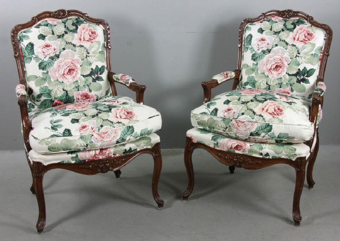 Pair of French Style Upholstered Armchairs: Pair of French-style carved armchairs having floral chintz upholstery, 38" H x 25" W x 29" D. Provenance: Richard and Phyllis Krock family.