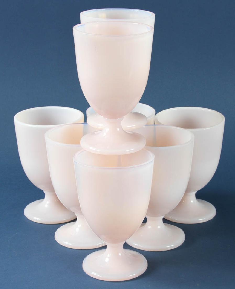 Fenton Shell Pink Milk Glass Goblets: Group of eight Fenton shell pink milk glass goblets, 6 1/4" H. Provenance: Studio Props of Martha Stewart.
