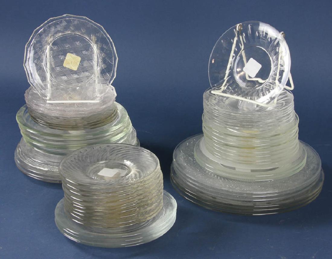 Group of Colorless Glass Plates: Group of colorless glass plates, 56 pieces total, largest plate measures 10 3/8" in diameter. Provenance: Studio Props of Martha Stewart.