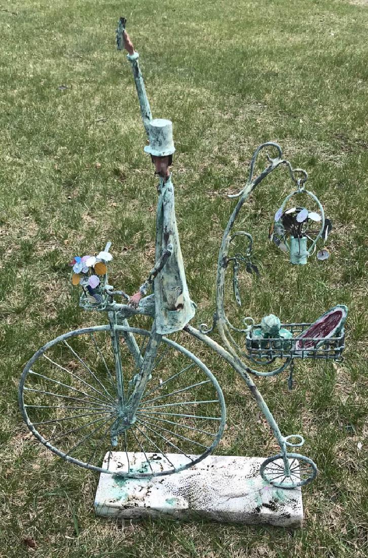 Folk Art Copper Statue of Man Riding Bike: Folk Art copper statue of man riding a high wheel bike, on base, 39" H x 25". Provenance: A Massachusetts collection.