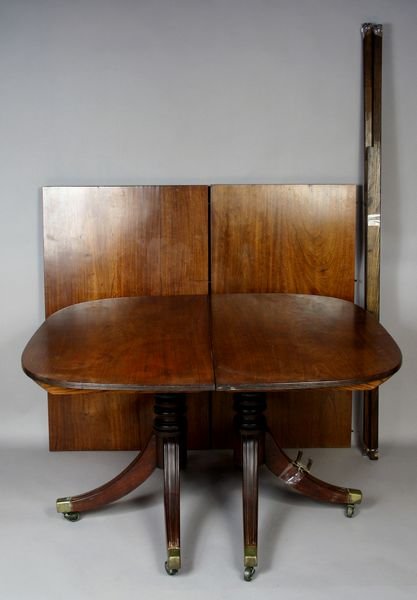 19thC American Double Pedestal Mahogany Table: 19th Century American Duncan Phyfe-style double pedestal mahogany table with two leaves, brass casters with end caps, 27 1/2"h. x 90"l. x 44 3/4"w. Water stain to one leaf, overall good condition.