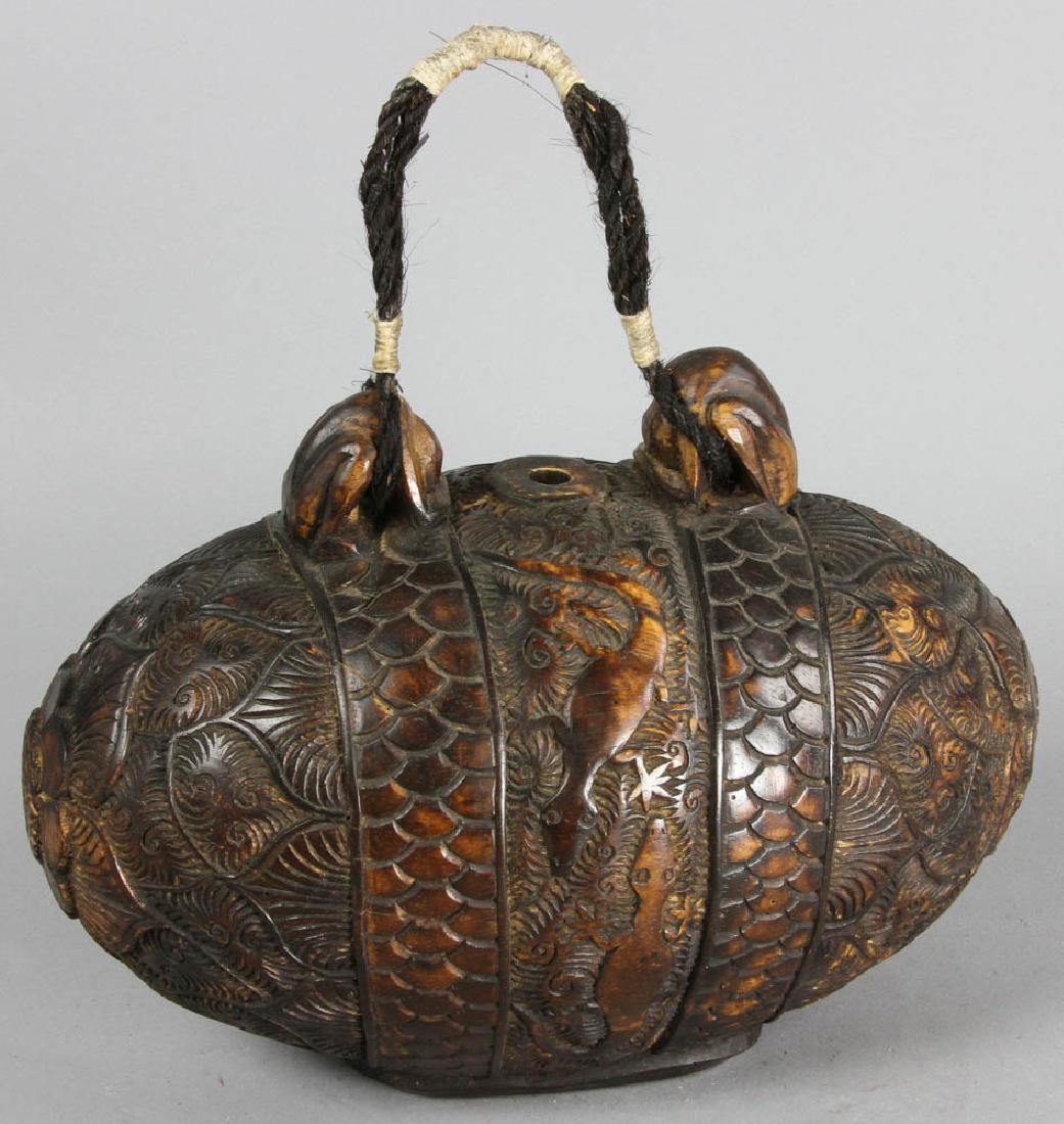 Indonesian carved Wood Medicine Chest: Indonesian carved wood medicine chest, 7" diameter x 11 1/2" L. Provenance: South Hamilton, Massachusetts estate.