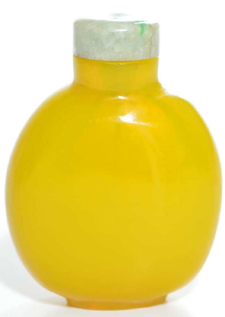 A Fine Chinese Peking Glass Snuff Bottle: Finely shaped bottle with straight neck covered in perfectly distributed imperial yellow tone. Jadeite stopper. Imperial workshop, Peking, 1800s. 3" H.