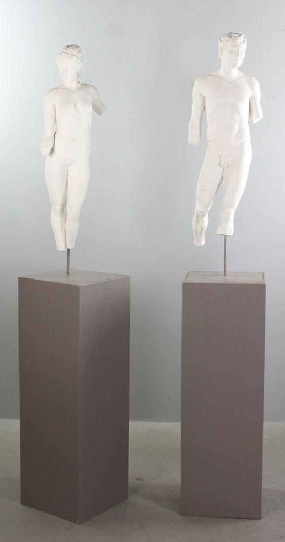 Pair of Nude Male and Female Statues: Pair of plaster statues, nude male and female, on stands, 30" H, 70" H (with stands). Provenance: Atlanta, Georgia collection.