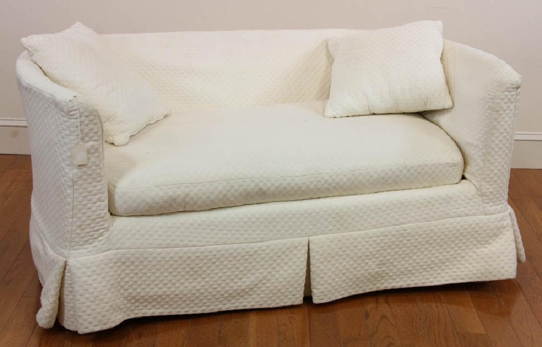 Loveseat with Cream Slip Cover: Loveseat with cream slip cover, 26" H x 58" W x approximately 34" D. Provenance: West Palm Beach, Florida estate.