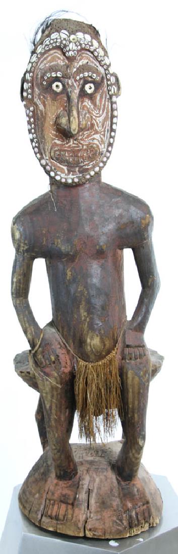 Polynesian Carved Wood Figure Of a Man: Polynesian carved wood figure of a man, polychrome and shell decoration, 46" H. Provenance: South Hampton, New York collection.