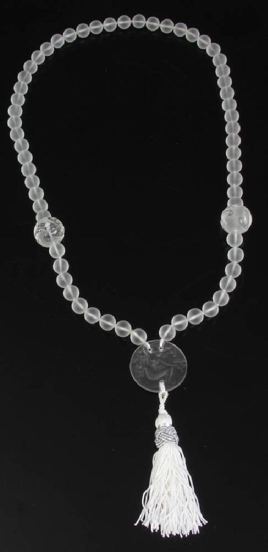 Lalique Beaded Necklace with Nymph Medallion: Signed R. Lalique necklace having frosted carved beads and nymph medallion with silk tassel, Fioret, Paris, 16" L, pendant 1 1/4" diameter. Pendant was designed as hang tag for Fioret Chose Promise pe