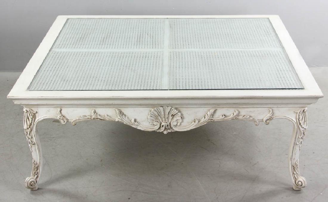 Louis XVI Style Painted Cocktail Table: Louis XVI-style painted cocktail table with glass over cane top, 17" x 47 1/2" x 47 1/2" . Provenance: West Palm Beach, Florida collection.