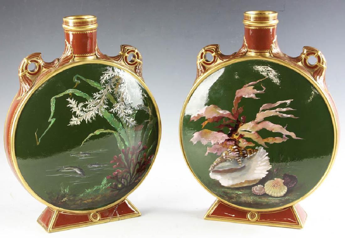 Pair Minton Shell Motif Moon Flask Vases: Pair of Minton hand-painted and glazed terracotta moon flask vases with shell and seaweed motif, artist signed, one with damaged base, 16 3/4" H x 12 1/2". Provenance: Chelsea, Massachusetts collectio