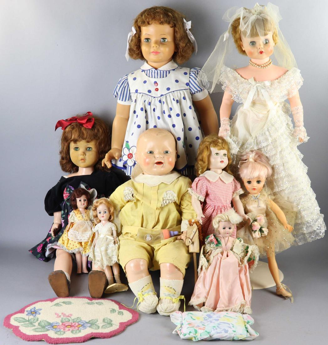 Group of Dolls, Effanbee, Ideal, Etc.: Group of dolls, nine (9) in total to include E.I.H. Co. Inc., Ideal Doll Co., Effanbee, etc., most with sleep eyes, various compositions, together with some doll's clothing, small needlework rug, etc.