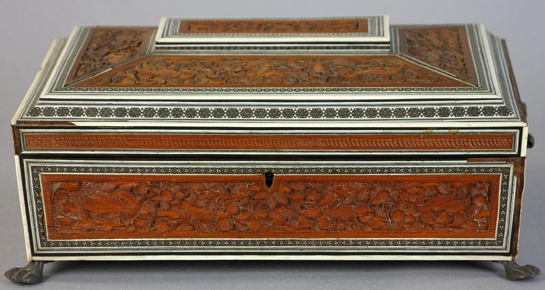 Circa 1860 Anglo Indian Carved Wood Sewing Box: Circa 1860 Anglo-Indian finely carved wood work box with floral and fauna motif, decorative bone and steel edging, bronze paw feet, fitted interior with original bone thread winders and holders, origi