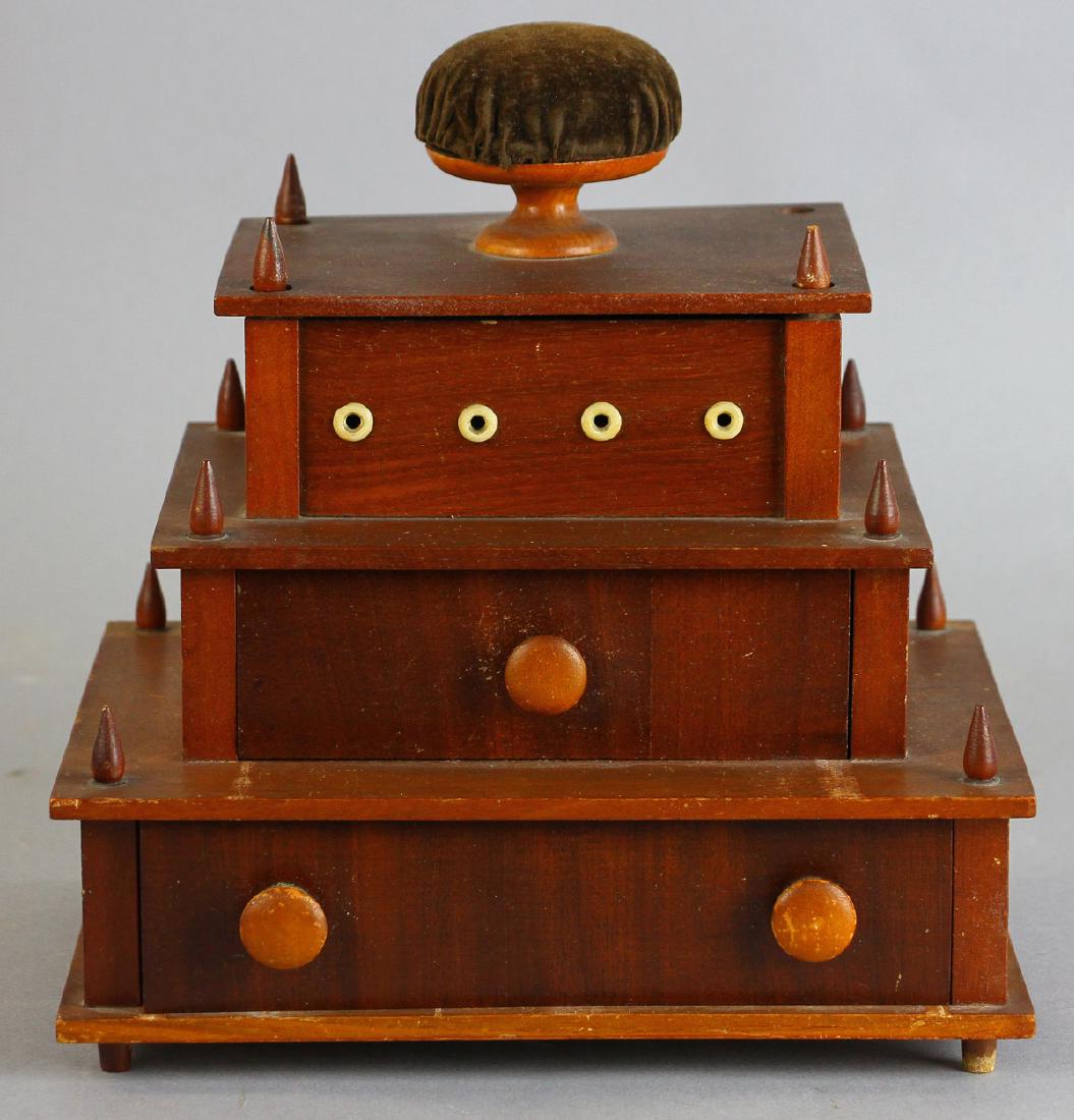 Shaker Cherry Sewing Work Box: Shaker cherry two-drawer sewing work box with upper thread holder compartment fitted with spool holders and bone eyelets and velvet-covered top pin cushion, 9 1/2" H x 8 3/4"W x 6 3/8" D.