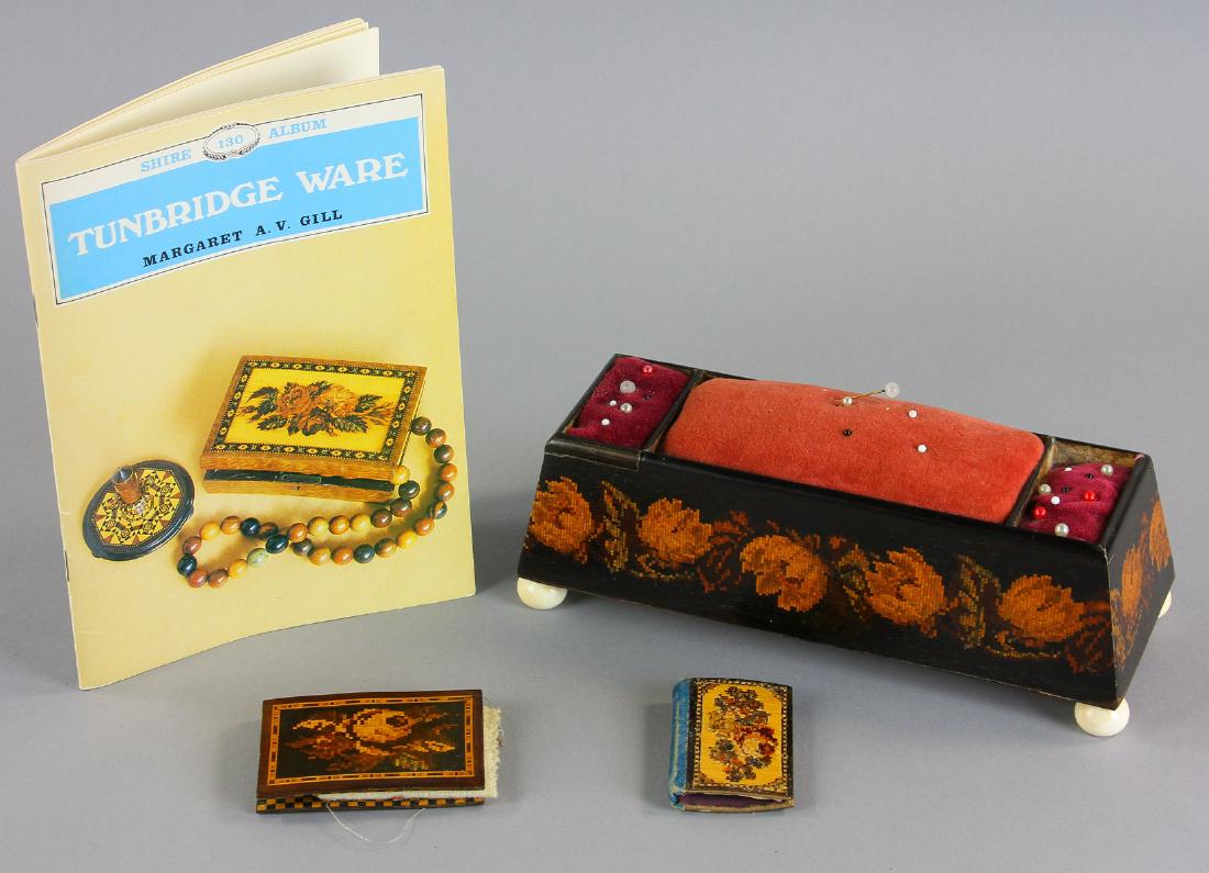 19th C Tunbridge Ware Mosaic Design Pieces: 19th century Tunbridge ware mosaic design pieces (worked in tesserae) to include large three-sectioned pin cushion on bone feet and two book-form needle cases, together with book titled 'Tunbridge War