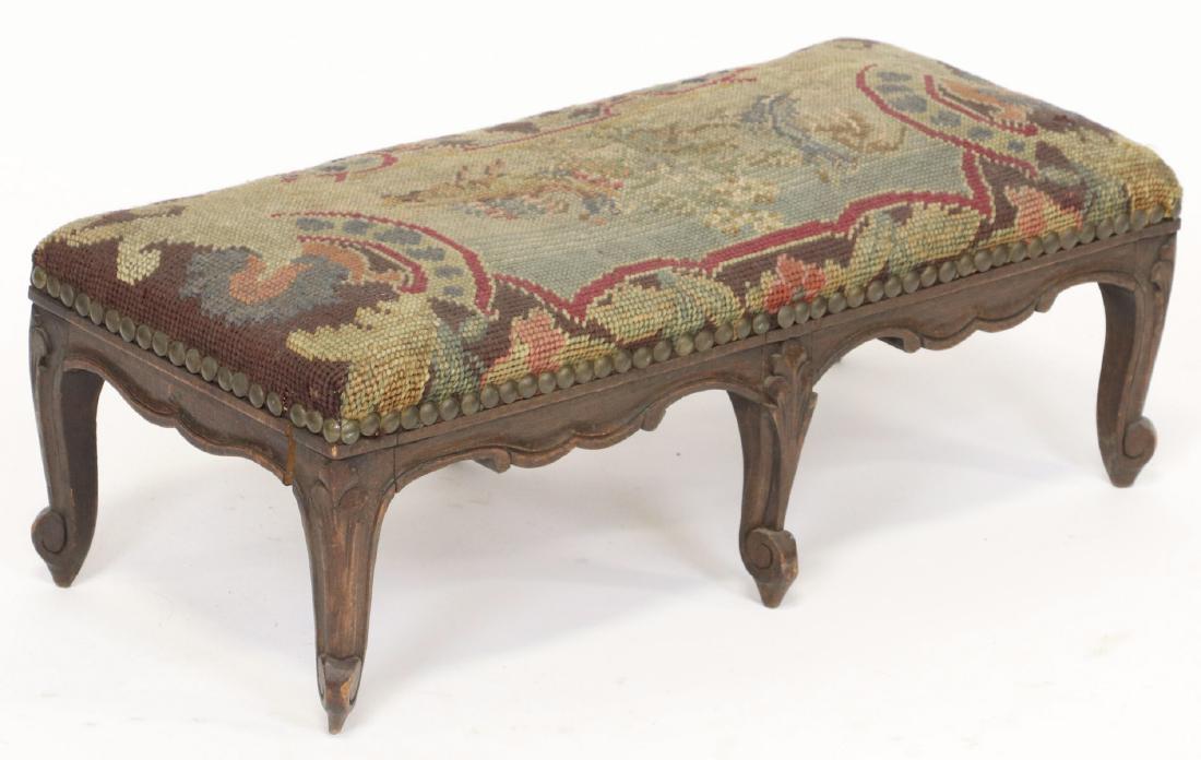French Needlepoint Footstool: French needlepoint footstool, 7" H x 20" W x 9" D.