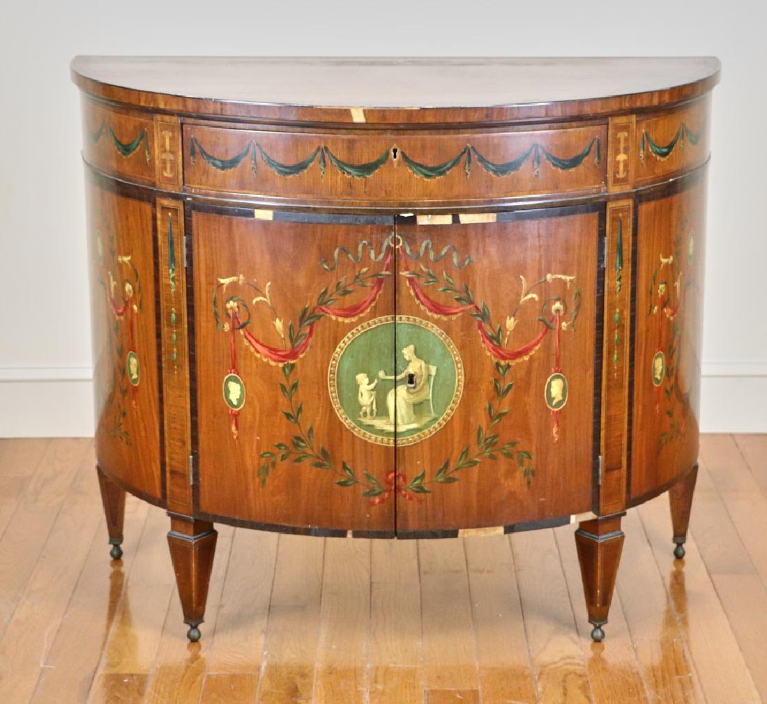 Early 20th C Demi Lune Cabinet: Early 20th century Adam-style demi-lune inlaid cabinet with hand-painted decoration, single drawer and two doors, 34" H x 41 1/2" W x 21 1/2" D veneer loss and finish wear. Provenance: Gloucester, Mas