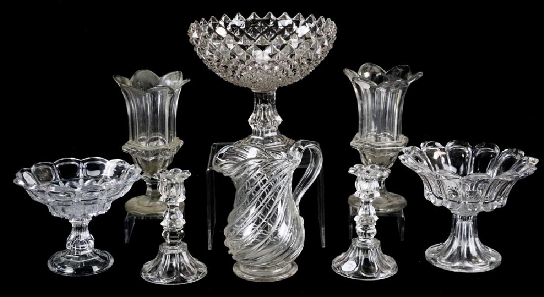19th Century Colorless Glass Pieces: Group of 19th century colorless glass items to include: pair of molded panel design celery vases; blown pitcher (possibly Pittsburgh Glass); pair of Sandwich Glass candlesticks, Petal and Loop pattern