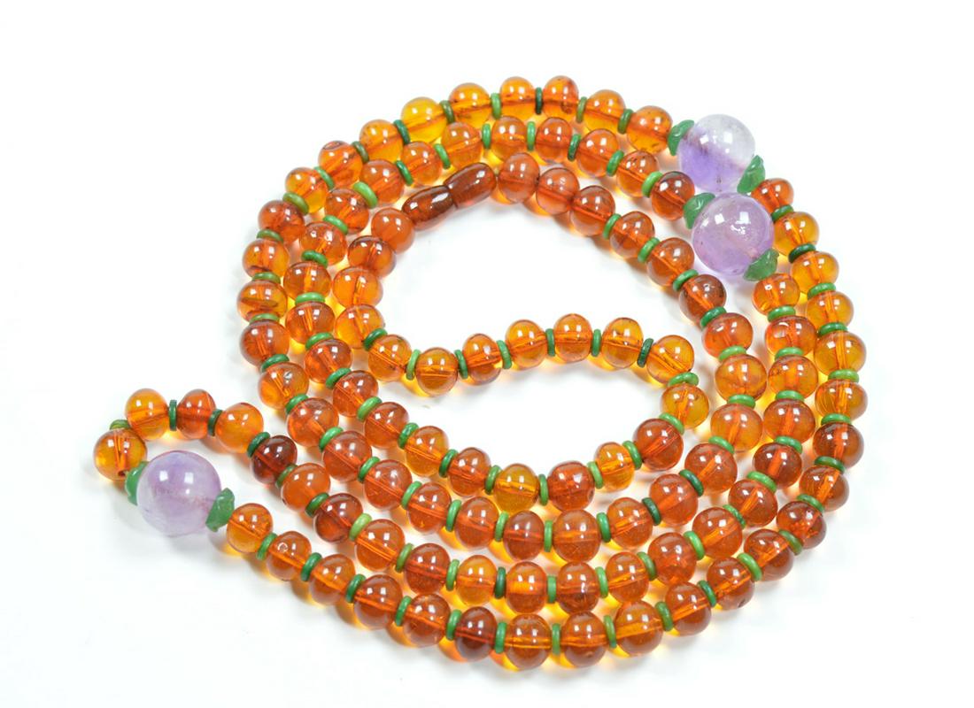 Fine 108-Beads Chinese Amber Necklace: Buddhist Malas consisting 108 Manchurian amber beads in 1850Ã¢€â„¢s pressed-style crafting, each separated with dyed pieces and accompanied by large amethyst beads and jade pieces. Possibly