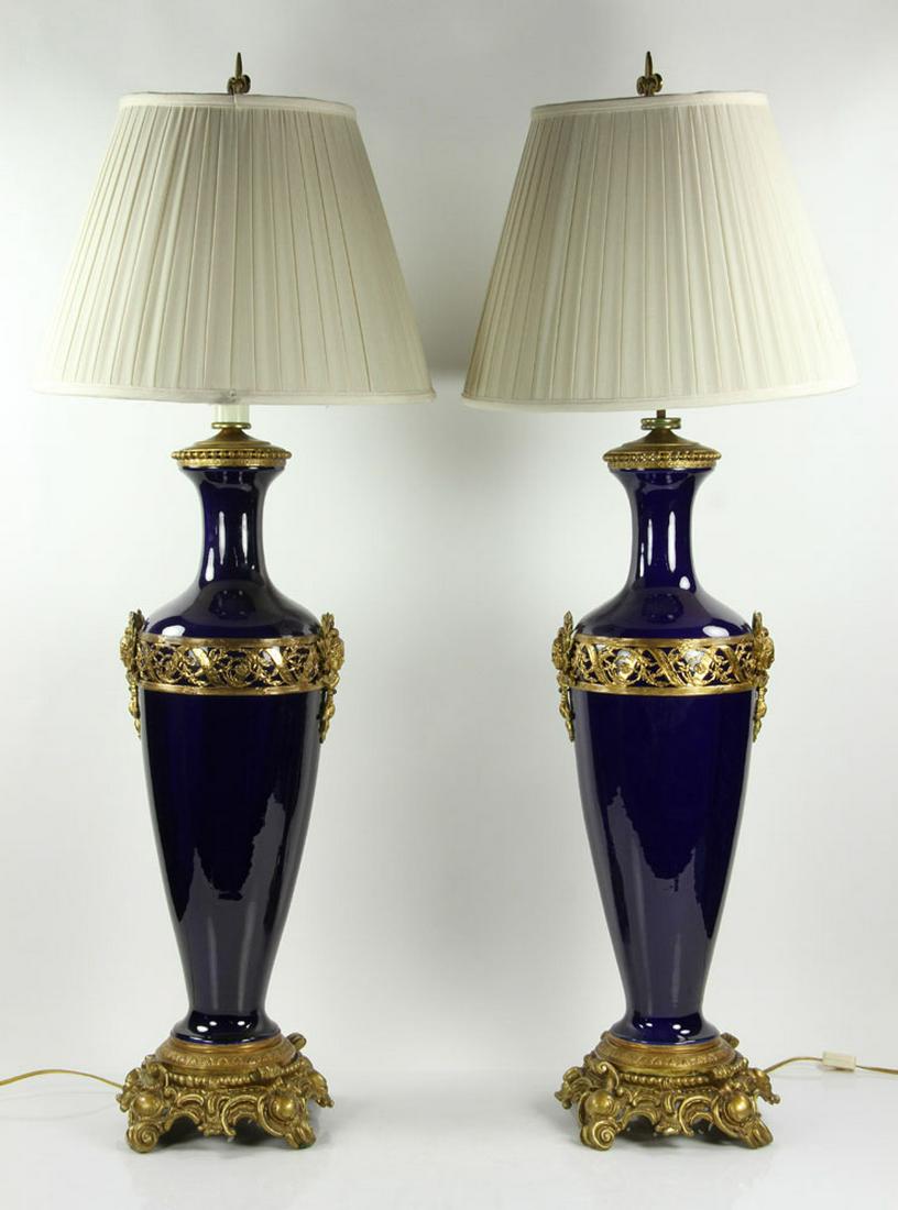 Pair of Porcelain and Ormolu Lamps: Pair of large French cobalt-glazed porcelain lamps with ormolu mounts, 41" H x 18" diameter. Provenance: Massachusetts estate. Provenance: Massachusetts estate.
