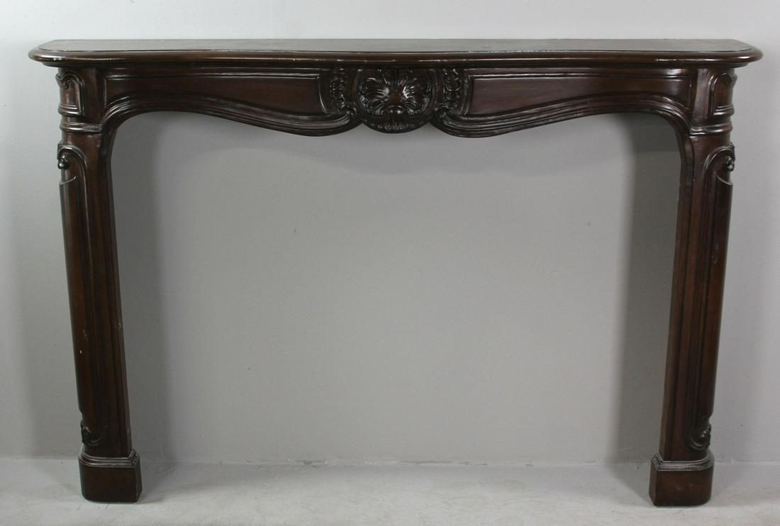 Carved Mahogany Mantel and Surround: Carved mahogany fireplace mantel and surround, 46" H x 69" W x 12" D. Provenance: West Palm Beach, Florida collection.