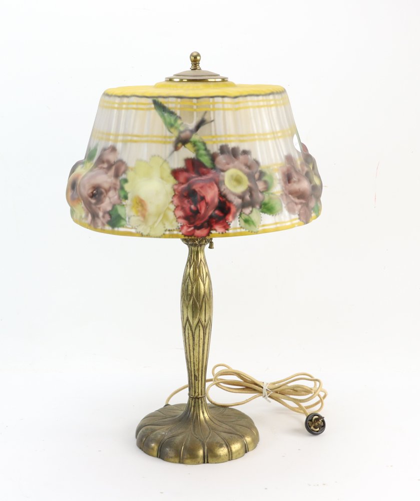 Pairpoint Puffy Table Lamp with Shade: Pairpoint "puffy" reverse-painted table lamp, Stratford shade with hummingbirds and roses, gilt metal base signed "Pairpoint" and with the "P" in diamond mark. Original cloth wiring. Lamp base 20" H t