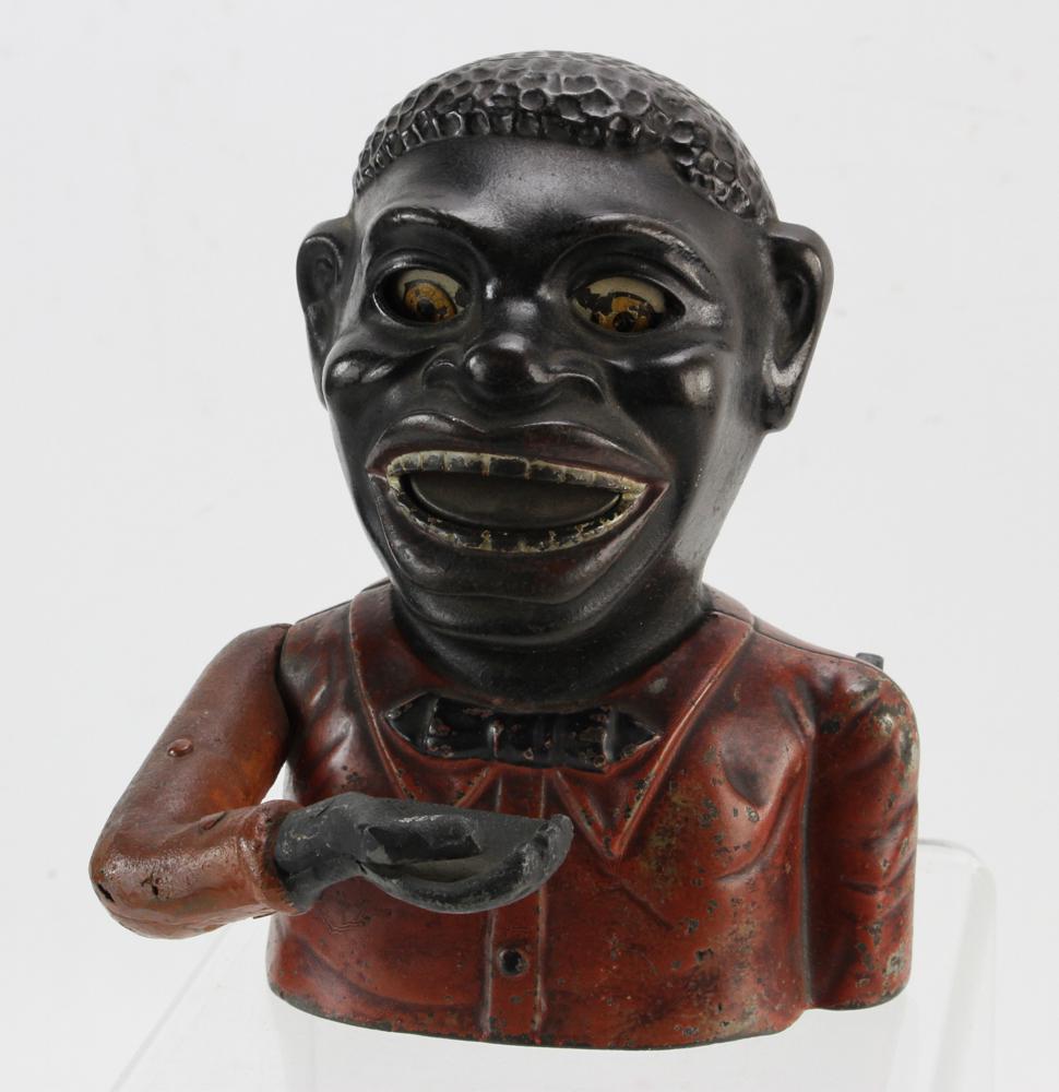 19thC Black Americana Jolly Boy Mechanical Bank: 19th century cast iron Black Americana Jolly Boy mechanical bank, bank name and maker's mark on back, "Pat. Mar 14 '82", on base "Manufactured by the J.A.E. Stevens Co. Cromwell Conn. USA", 6 1/2" H x