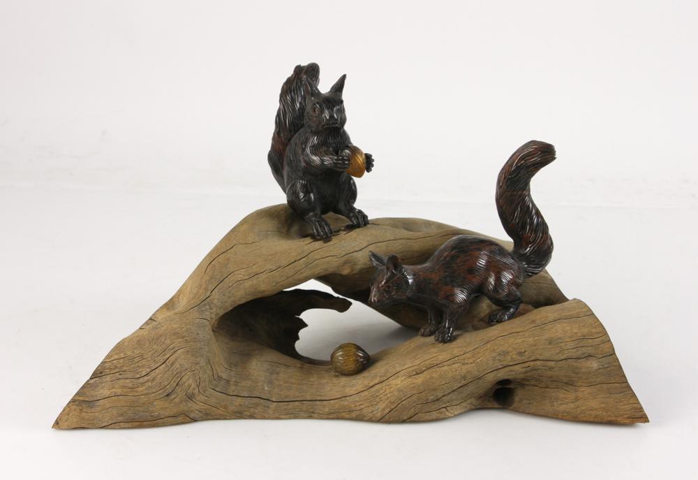 European Carved Tiger's Eye Squirrels: European carved tiger's eye squirrels on a natural wood base, with two walnuts, 7 1/2" H x 13 1/2". Provenance: From the Keenan Family estate of North Miami, Florida.