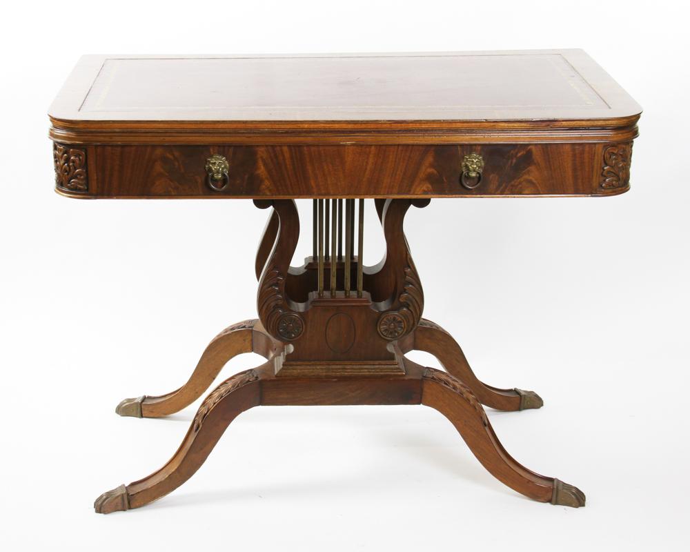 Duncan Phyfe Style Game Table: Duncan Phyfe-style game table with leather top and carved base, 30 1/2" H x 40" W x 21" D. Provenance: from a Swampscott, Massachusetts collection.