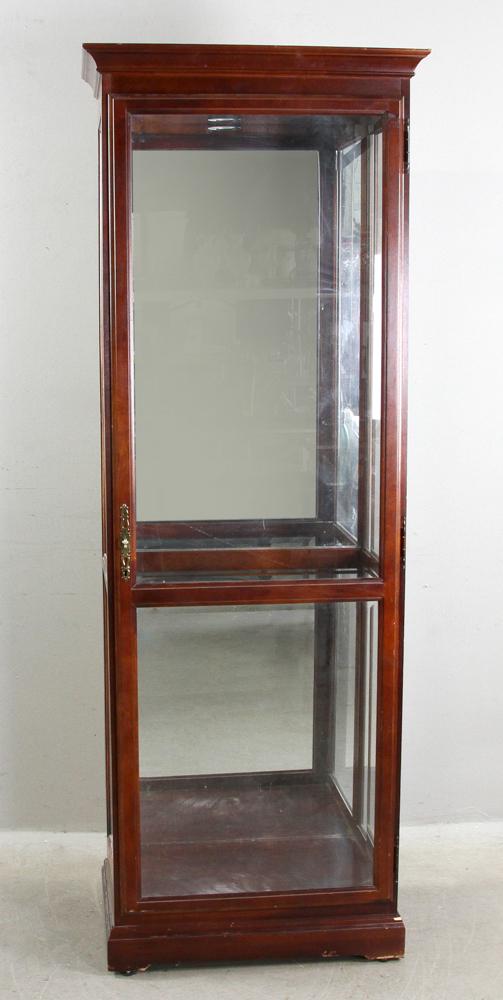 Howard Miller Collector's Cabinet: Howard Miller collector's cabinet with mirrored back, glass sides, beveled glass door, four (4) adjustable glass shelves and center light , 78" H x 28" W x 17" D. Provenance: North Andover, Massachuse