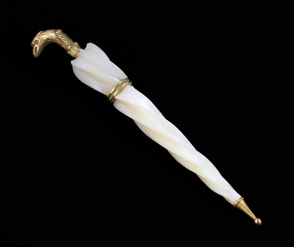 Umbrella Form Needle Case: Umbrella form brass and mother-of-pearl needle case with eagle head top, 4" L. Provenance: Estate of Alfreda Rochelle-Thomas, Palm Beach, Florida.