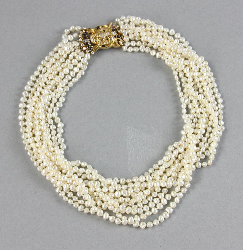 Ten Strand Pearl Necklace, 18K Gold Clasp: Ten-strand baroque freshwater pearl necklace with 18k yellow gold, diamond and sapphire lion-form clasp, 18 1/2" L, approximately 25 grams total gold weight. Provenance: Beverly, Massachusetts collect