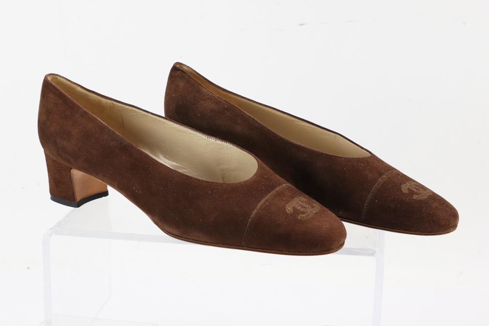 Chanel Chocolate Brown Suede Pumps: Chanel chocolate brown suede pumps with low block heel Chanel logo toes, size 39 European, 8 1/2 US. Provenance: From a Beverly, Massachusetts estate.
