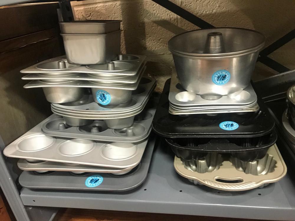 Baking Pans and Cupcake Molds: Large collection of baking pans and cupcake molds.