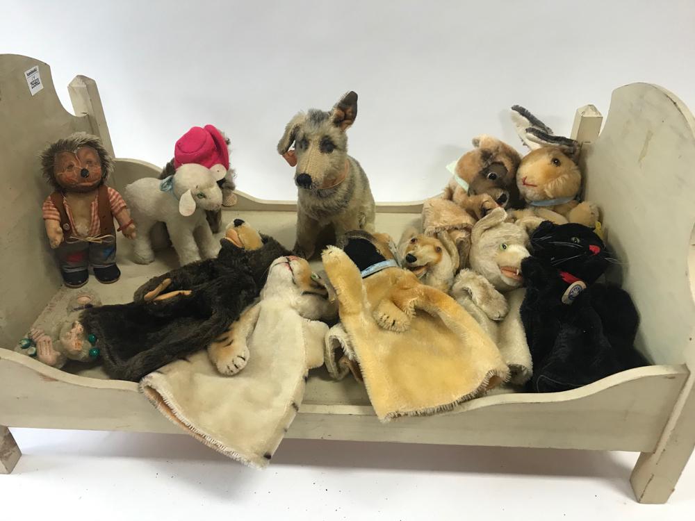 Steiff and Other Animals and Puppets: Group of Steiff, and other manufacturers, animals and puppets, to include: dog, white lamb, bear, bulldog, tiger, black cat, fox, polar bear, etc, (13) total, many with button in ear, all in a white d