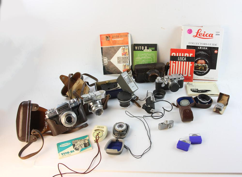 Group of Cameras and Photo Equipment: Leika camera with flash and filters; Voigtlander camera with extras; Zeiss Ikon camera; Meccano No1 Clockwork Motor, works. Provenance: From a South Hamilton, Massachusetts estate.