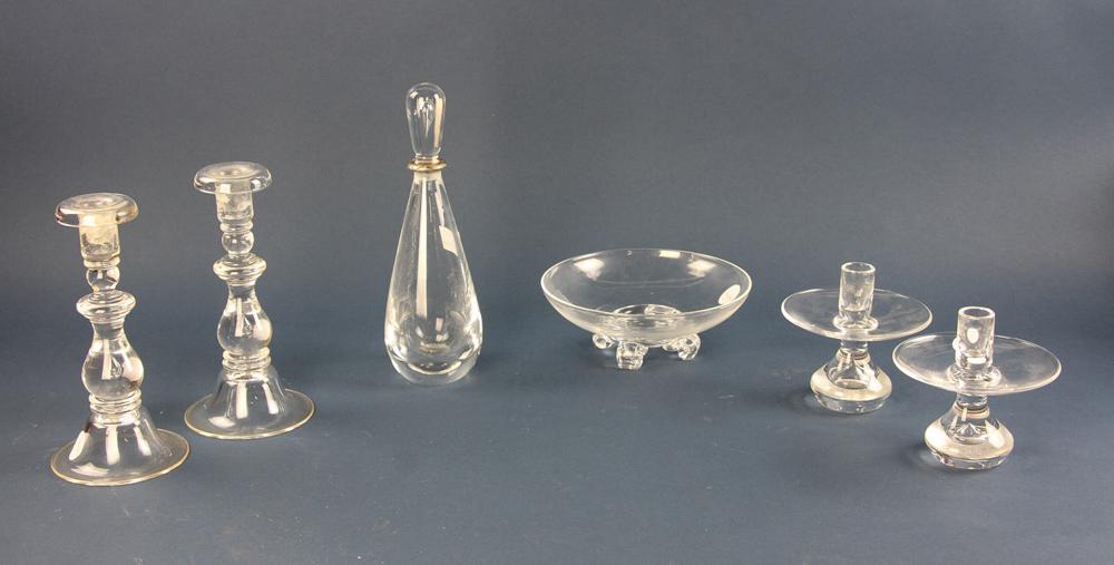 Collection of Steuben Glass: Collection of Steuben glass, to include: two pairs of candlesticks (short and tall), tear drop shaped decanter with sterling rimmed stopper, and a fruit bowl. Provenance: From an Acton, Massachusetts 
