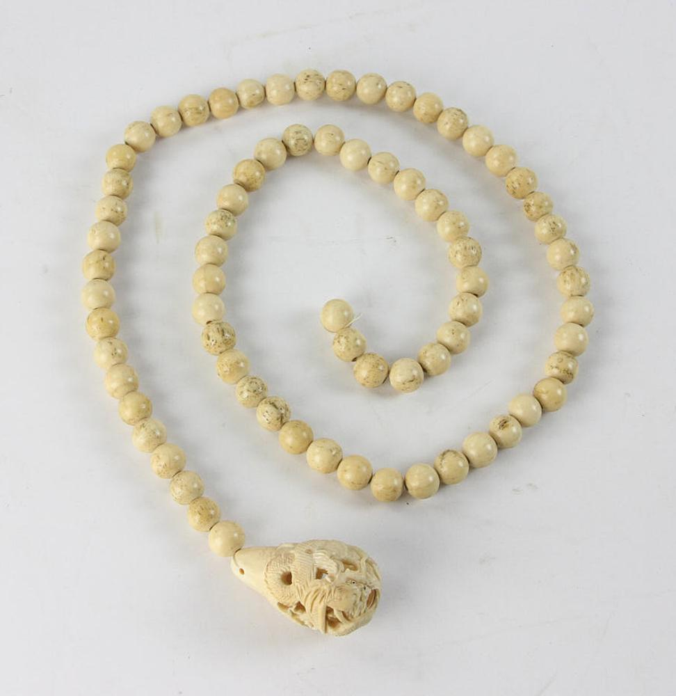 Antique Chinese Carved Bone Necklace: Antique Chinese carved bone necklace, dragon design, 24" L, 2" pendant. Provenance: From a Saugus, Massachusetts estate.