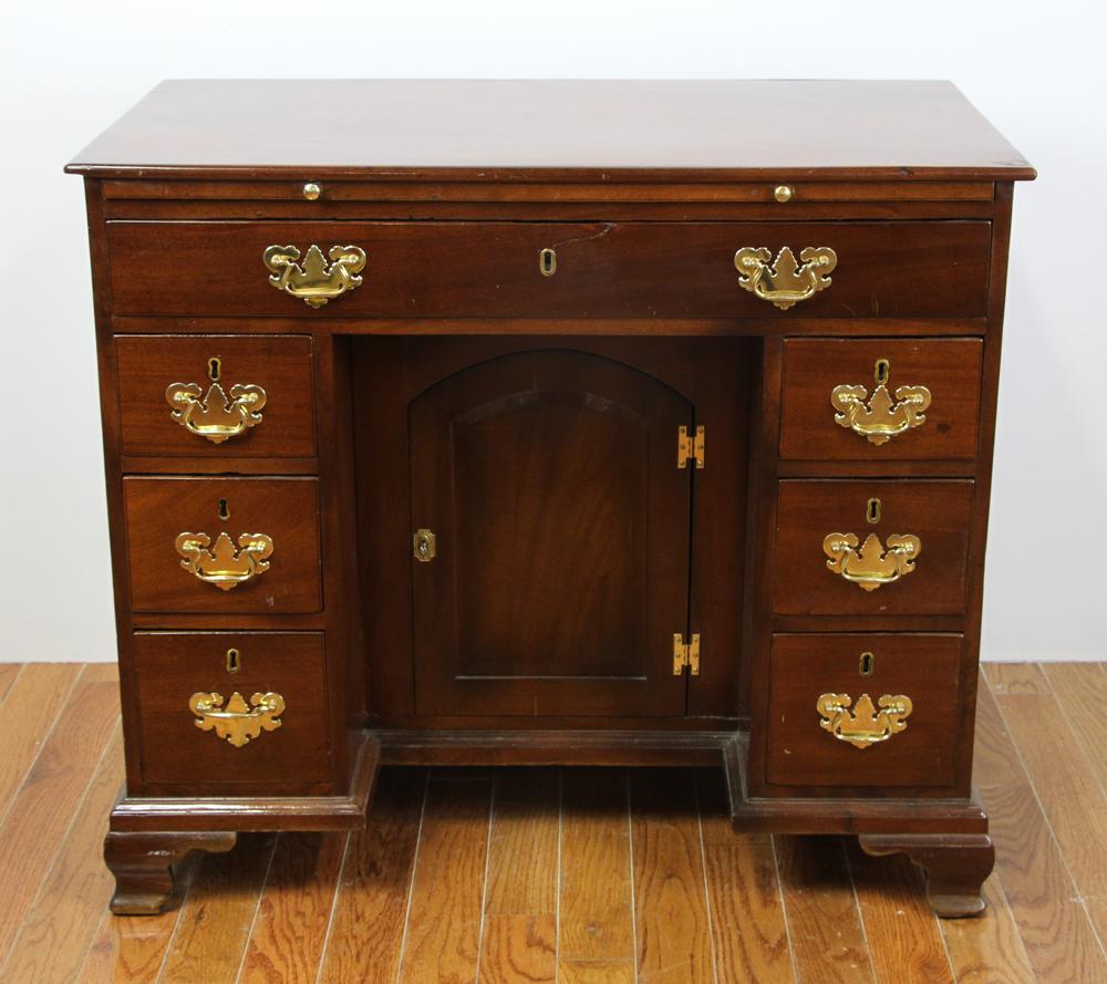 18thC Chippendale Kneehole Desk: 18th century Chippendale kneehole desk with center door, brass hardware, slide out writing surface, 33" H x 37 1/2" W x 20" D. Provenance: From a Wantagh, New York estate.