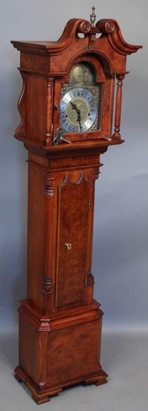 20th C. Grandmother Clock French Walnut: 20th Century grandmother clock, French walnut and mahogany, face marked "John Thompson London", with keys and pendulum, 56 1/2"h. x 14 3/4"w. x 8 3/4"d. Good condition; working order.