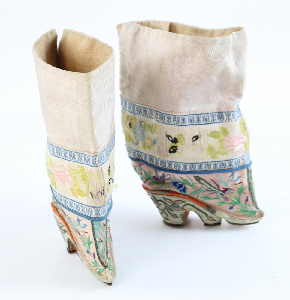 Pair of Early 20th Century Chinese Embroidered Boots: Pair of Chinese embroidered boots, likely made in Shanghai in the early 1900's, pictured on page 142 of 'Splendid Slippers' by Beverley Jackson, 3 /12" long by 6" high. Provenance: From the collection