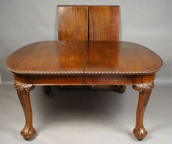 English Dining Table w/ Ball-and-Claw Feet: English dining table with ball-and-claw feet, rope carved edge, and carved knees, with two leaves, 29 1/2"h. x 62 1/2"w. (not including the two 16 1/2" leaves) x 48"d. Good condition; includes brass c