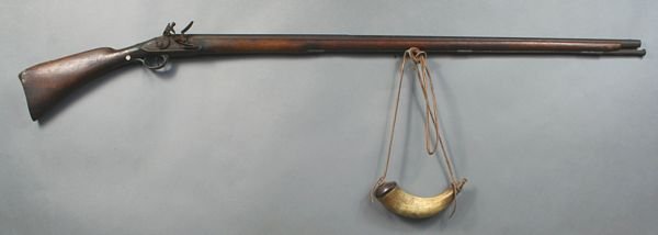 C1800 New England Fowler w/ Powder Horn: Circa 1800 New England fowler with powder horn, 61"l. overall, 45 1/4" barrel transitions from hexagonal shape to round, plate decorated with tulip design, wood stock with brass butt and thumb rest. I