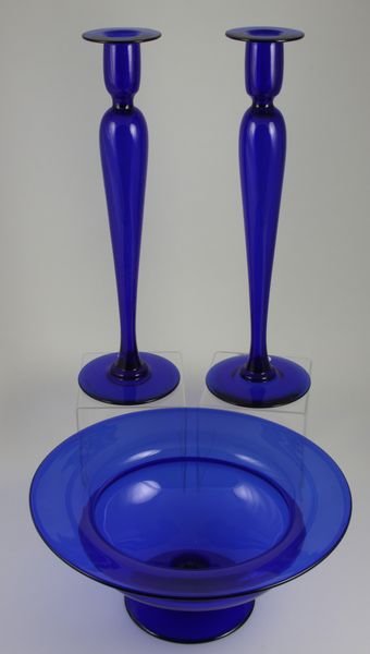 Early 20th C. Pairpoint Blown Glass Console Set: Early 20th Century Pairpoint blown glass console set, to include footed center bowl, 5 1/2"h. x 12"dia. and pair of candlesticks, 15 3/4"h., deep cobalt. All in good condition.