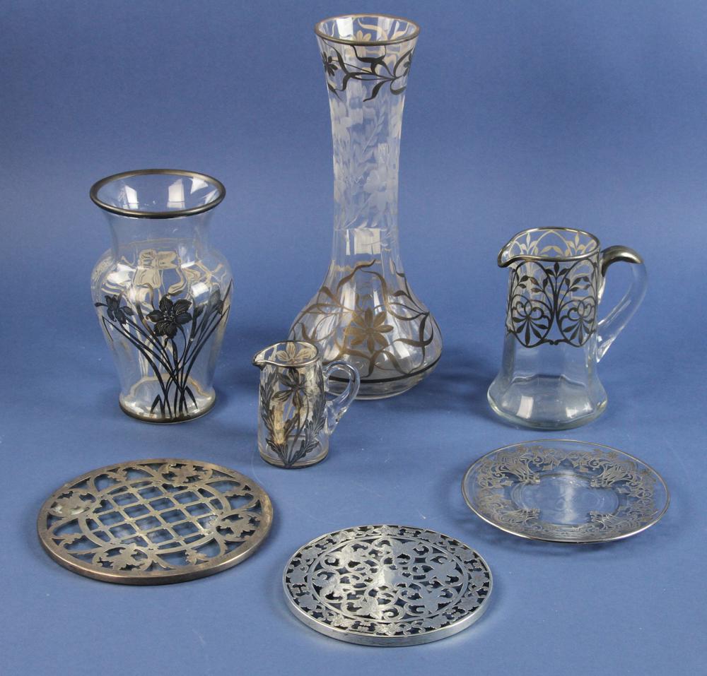 Collection of Silver Overlay Glass: Collection of silver overlay glass to include pitchers, vases and trivets, seven (7) pieces total, tallest 12 1/2" H. Provenance: Estate of Norma Szaro, Swampscott, MA.