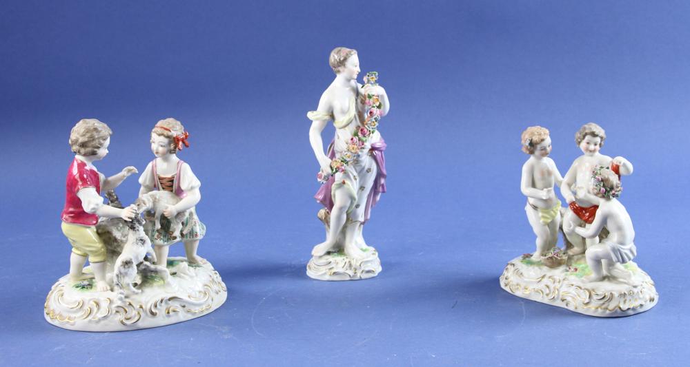 Meissen and Meissen Style Figurines: Meissen figure of woman with floral garland together with two Meissen-style porcelain groupings, pastoral motif and young children, three (3) pieces total, tallest 7 1/2" H. Provenance: Estate of Norm