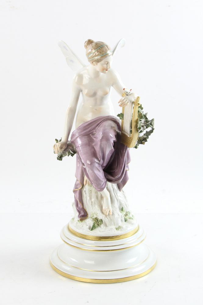 Meissen Figure of Winged Woman: Meissen figure of winged woman with arm on lyre and butterfly resting on hand, blue underglaze mark, 17" H x 8" base diameter. Note: Some damage to tips of leaves. Provenance: Estate of Norma Szaro, S